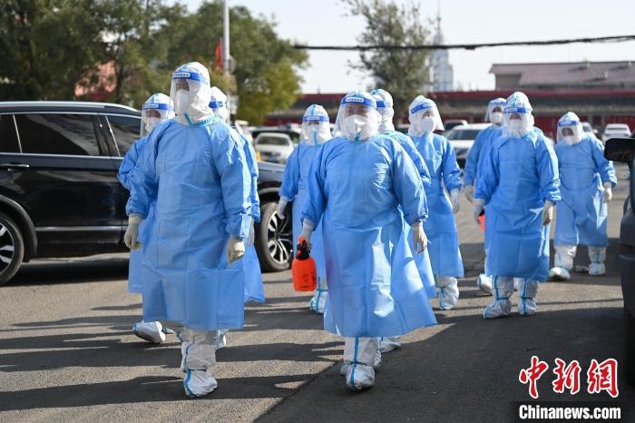 圖為醫(yī)務(wù)人員在封閉小區(qū)做防控工作。　劉文華 攝