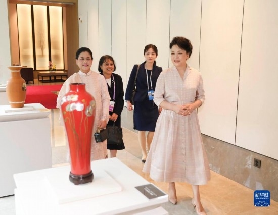 7月27日下午，國家主席習近平夫人彭麗媛在四川成都會見陪同印度尼西亞總統佐科來華出席第31屆世界大學生夏季運動會開幕式并訪華的總統夫人伊莉亞娜。這是彭麗媛和伊莉亞娜欣賞成都特色非遺工藝品。新華社記者 丁林 攝