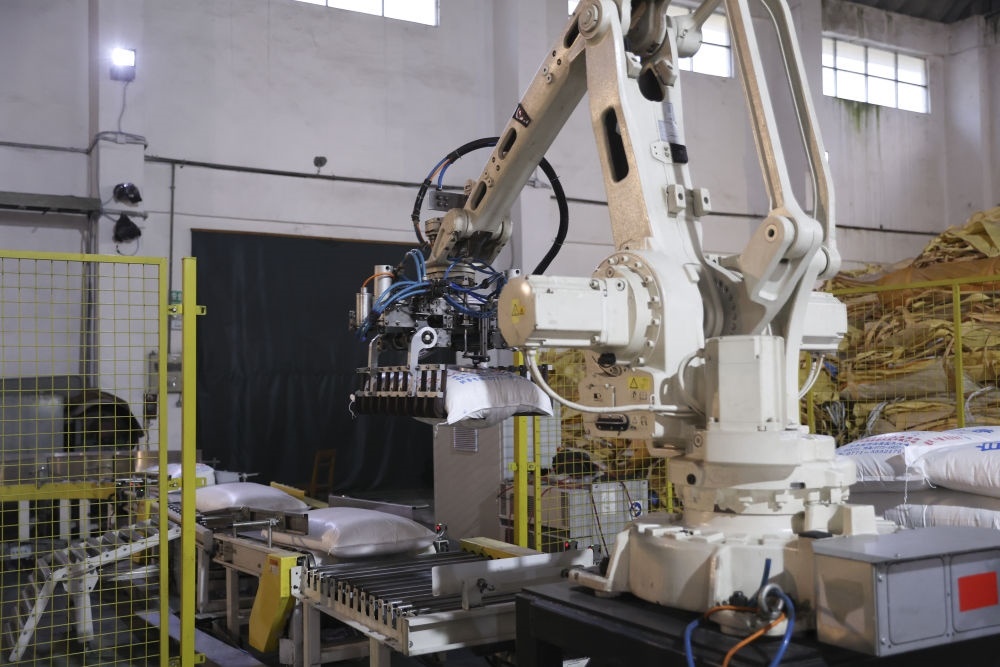 12月14日，在廣西來(lái)賓東糖鳳凰有限公司，機(jī)械臂在廠房碼放白砂糖成品。