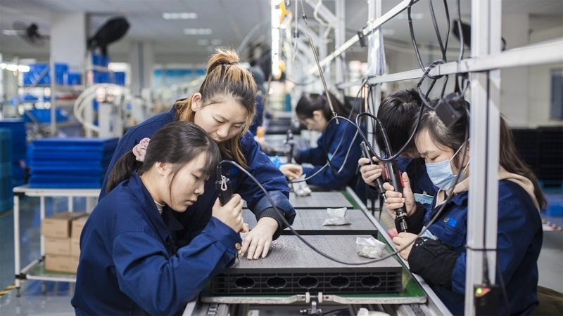 在新亞勝光電的產(chǎn)品線上，工人正進(jìn)行產(chǎn)品組建和安裝布線。受訪者供圖