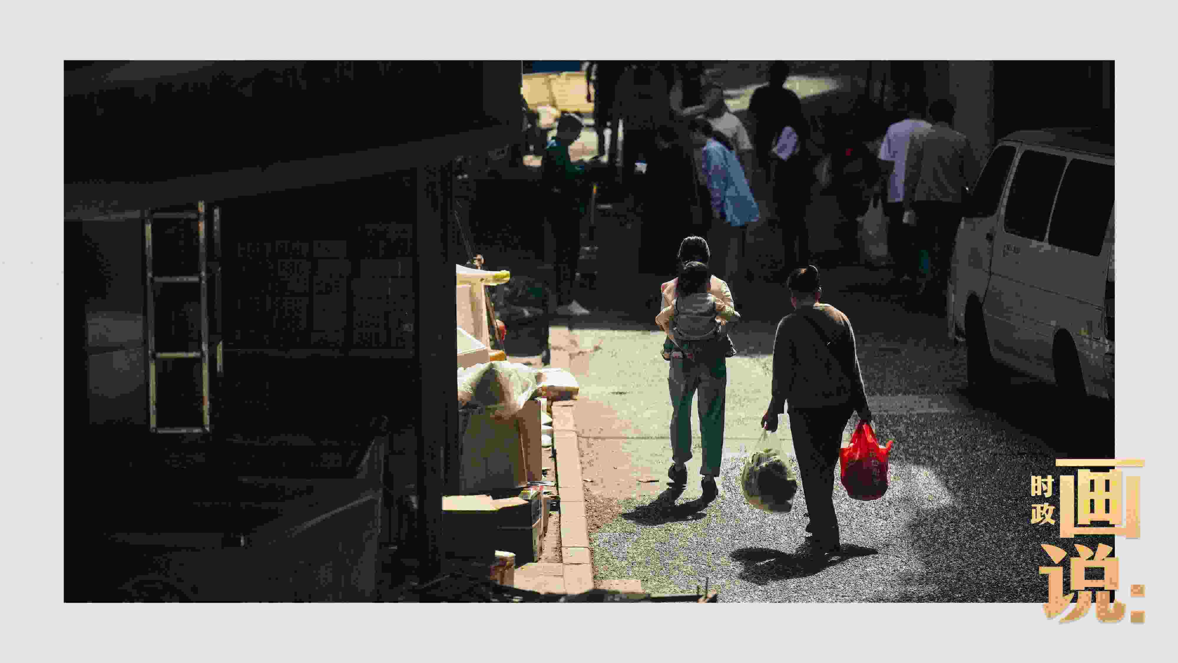 △老城區(qū)鱗次的樓宇間漏下一縷光，路人走過(guò)暖陽(yáng)。