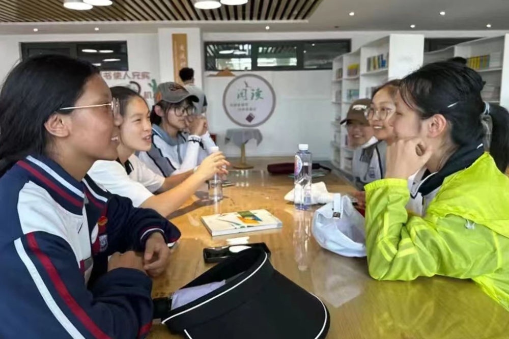 2023年7月10日，在果洛西寧民族中學(xué)，上海市大同中學(xué)學(xué)生（右）與果洛西寧民族中學(xué)學(xué)生交流。新華社發(fā)（果洛州教育局供圖）