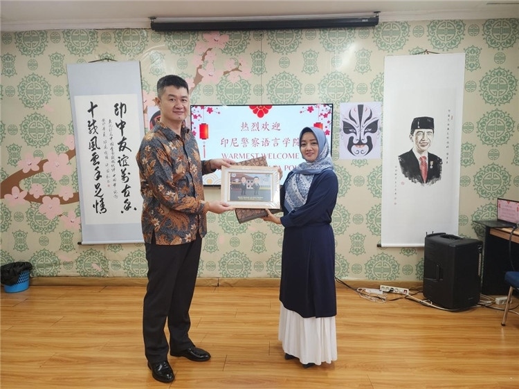 警察語言學(xué)院老師與王大昕交換禮品?；顒又鬓k方供圖