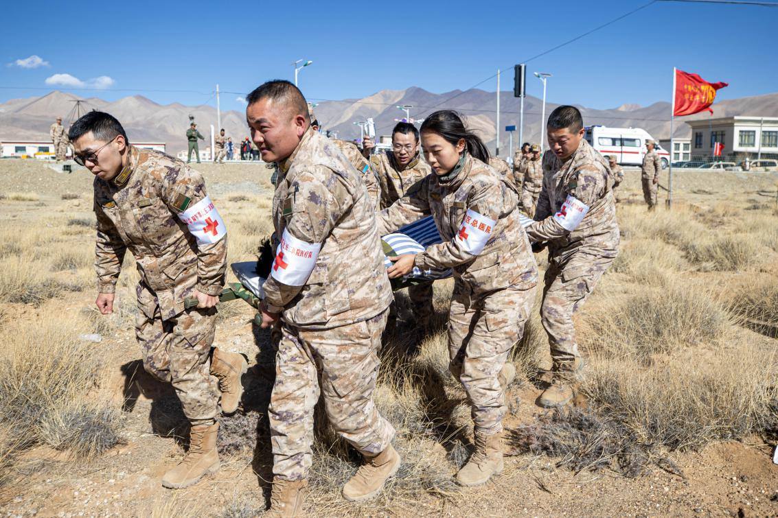 1月9日，日喀則定日縣長所鄉(xiāng)，西藏軍區(qū)總醫(yī)院醫(yī)療隊(duì)隊(duì)員將受傷村民用擔(dān)架從救護(hù)車準(zhǔn)備抬上直升機(jī)，轉(zhuǎn)運(yùn)至拉薩的西藏軍區(qū)總醫(yī)院救治。人民日?qǐng)?bào)記者張武軍攝