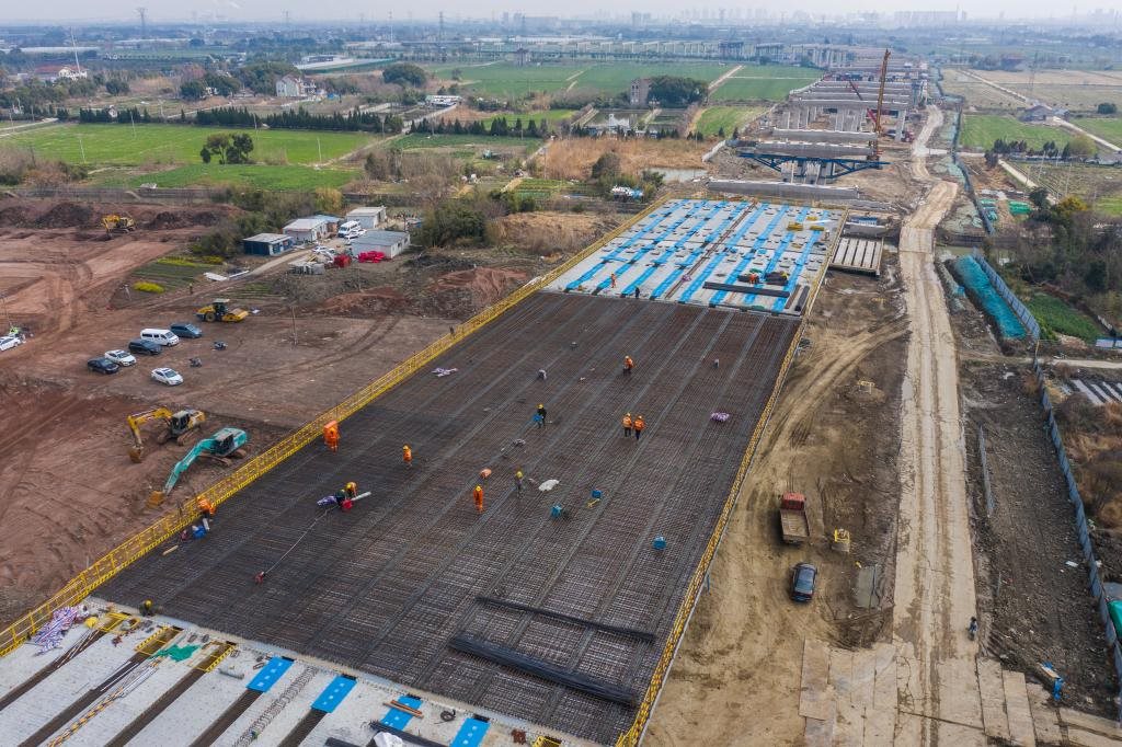 3月7日，在524國(guó)道秀洲王江涇至新塍公路工程TJ02標(biāo)段，作業(yè)人員正在進(jìn)行60米鋼混組合梁現(xiàn)澆橋面板鋼筋焊接及綁扎作業(yè)（無(wú)人機(jī)照片）。新華社記者 徐昱 攝